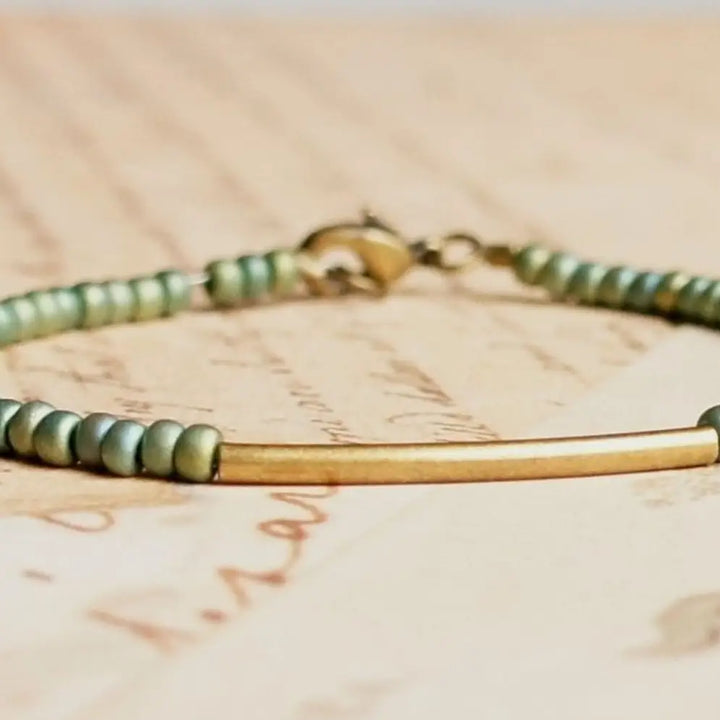 Metallic green seed bead, bronze bar bracelet